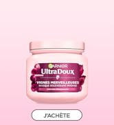 Le texte se lit comme suit : « J'ACHÈTE ». Le pot de produit de beauté rose avec couvercle sur fond rose semble être une crème ou un produit hydratant.